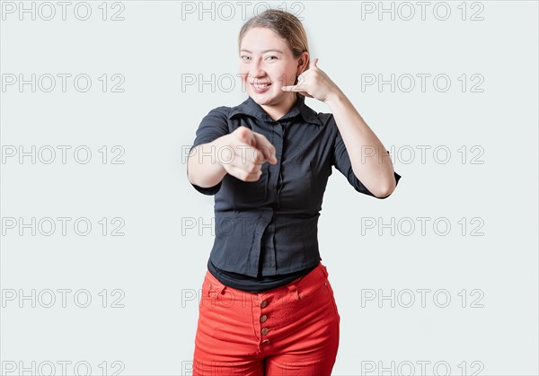 Smiling Beautiful woman gesturing call me and pointing at camera. Friendly girl gesturing call me with fingers isolated