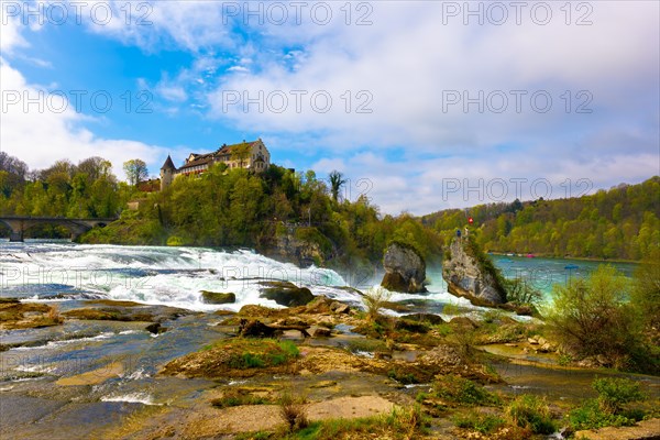 Rhine Falls and Swiss Flag with the Castle Laufen at Neuhausen in Schaffhausen, Switzerland, Europe