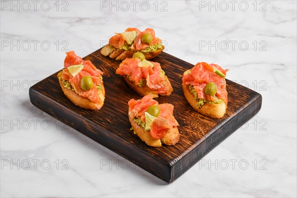 Sandwiches with salmon and mashed avocado