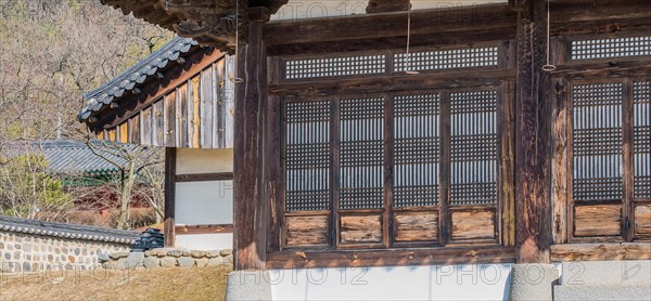 Oriental lattice work on doors of wooden building in a local woodland park in South Korea