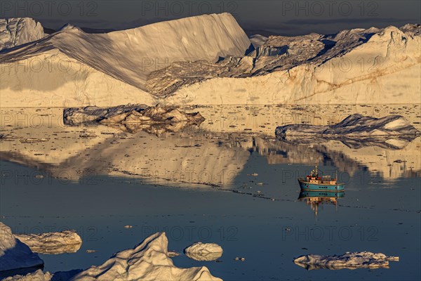 Boat in front of icebergs, reflection, midnight sun, summer, Ilulissat Icefjord, Disko Bay, Jakobshavn Glacier, Greenland, North America
