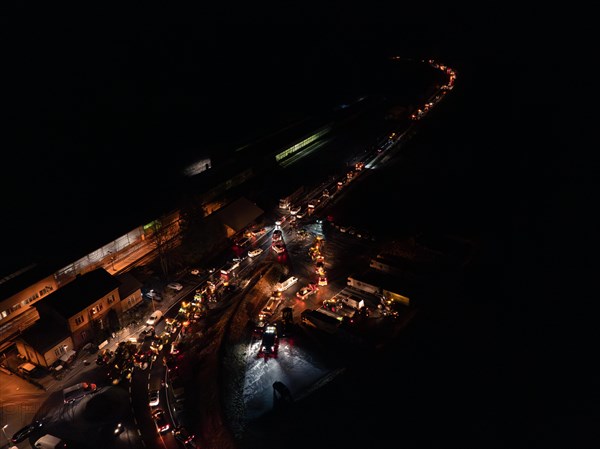 Night view of an illuminated road full of tractors and people, farmers protest, Black Forest, Bad Teinach, Germany, Europe