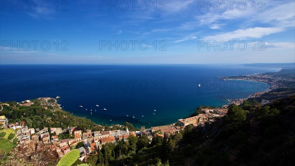 Breathtaking view of a coastal town with clear blue water and sky, boats in the sea, Taormina, Eastern Sicily, Sicily, Italy, Europe