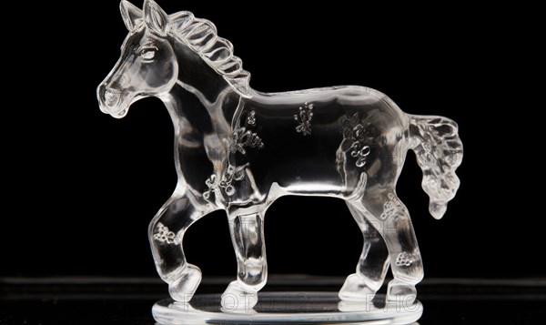 White horse running on the snow in winter. ice sculpture. glass figure of horse in dynamic pose AI generated