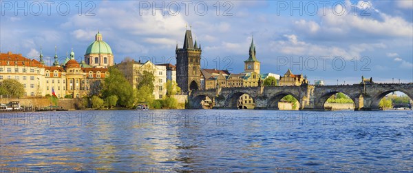 Panorama of old town with Charles Bridge on Vltava river and Old Town Bridge Tower, famous tourist destination in Prague, Czech Republic, Europe