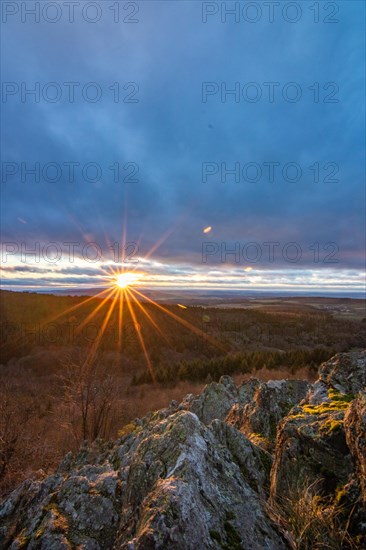 Landscape at the Grosser Zacken, Taunus volcanic region. A cloudy, sunny autumn day, meadows, hills, fields and forests with a view of the sunset. Hesse, Germany, Europe