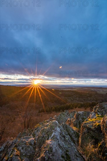 Landscape at the Grosser Zacken, Taunus volcanic region. A cloudy, sunny autumn day, meadows, hills, fields and forests with a view of the sunset. Hesse, Germany, Europe