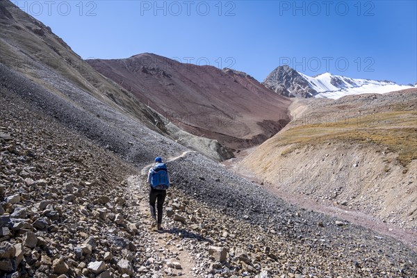Barren high mountains, hiker on the hiking trail to the base camp of Lenin Peak, Osh Province, Kyrgyzstan, Asia