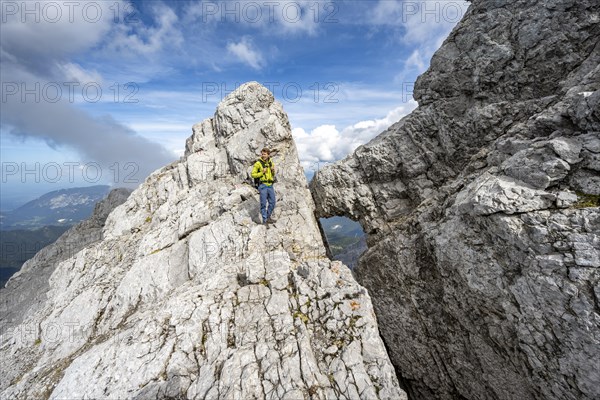 Mountaineer on a narrow rocky ridge, Watzmann crossing to Watzmann Mittelspitze, view of mountain panorama, Berchtesgaden National Park, Berchtesgaden Alps, Bavaria, Germany, Europe