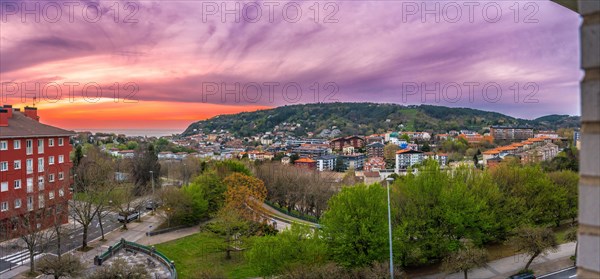 Panoramic sunset in Donostia San Sebastian from a high neighborhood and the sea in the background. Basque Country