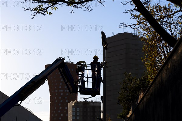 Silhouette of an electrician technician working in a financial area in Barcelona in Spain