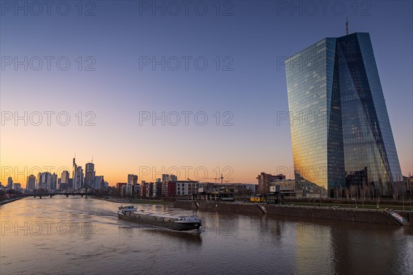 A ship sails past the European Central Bank (ECB) on the Main River in the evening, Frankfurt am Main, Hesse, Germany, Europe