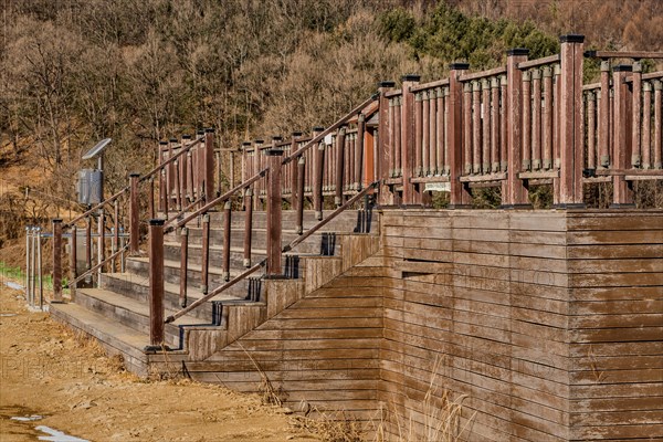 Wooden observation platform in wilderness park on sunny winter day