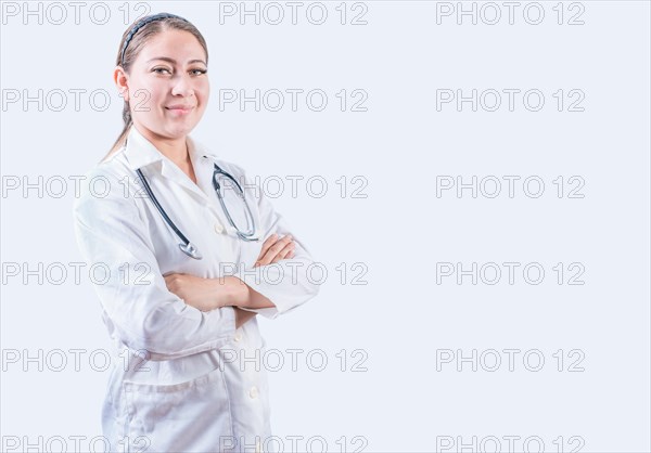 Portrait of smiling female doctor with crossed arms isolated. Successful female doctor with arms crossed isolated