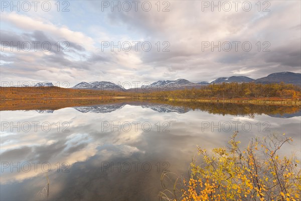 Abisko National Park in autumn, Lake Vuolep Njakajaure. Reflection of the mountains in the lake
