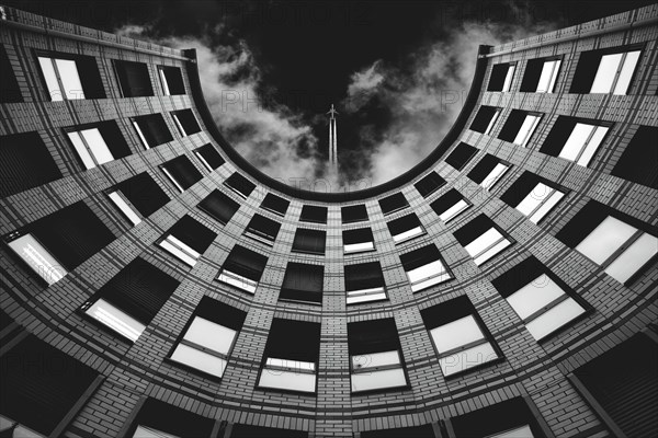 View upwards to a circular building in black and white with sky and clouds in the background, Friedrichstrasse, Wuppertal Elberfeld, North Rhine-Westphalia, Germany, Europe