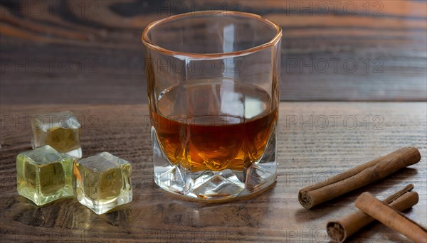 Whiskey with rocks or ice cubes in a glass with ice in a dark wooden background. AI Generated, AI generated