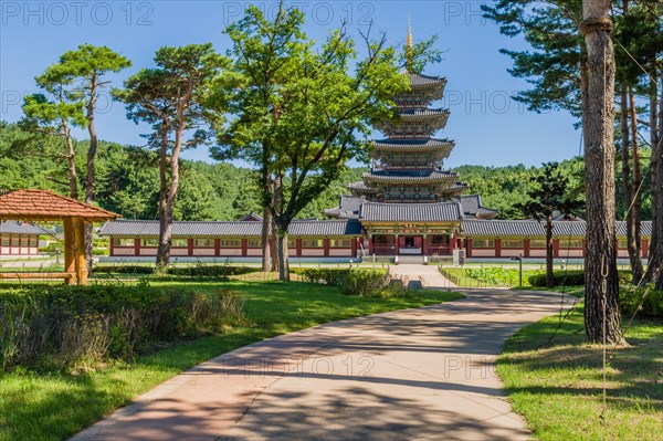 Buyeo, South Korea, July 7, 2018: Sidewalk leading to main gate of Neungsa Baekje Temple with five story pagoda, Asia