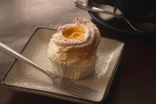 Close up of a brazo de mercedes cupcake, a popular authentic Filipino dessert. Dipolog, Philippines, Asia