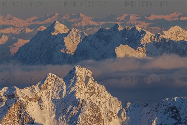 Mountain peak in the snow in the evening light, high fog, distant view, view from Zugspitze to Dreitorspitze and Karwendel Mountains, Wetterstein range, Bavaria, Germany, Europe