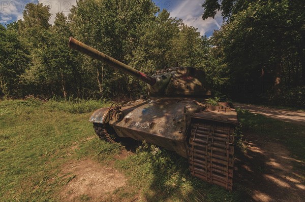 An old military tank with camouflage paint stands abandoned in the forest under broken sunlight, M47 Patton, Lost Place, Brander Wald, Aachen, North Rhine-Westphalia, Germany, Europe