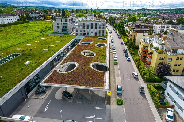 View from above of a building with a green roof, neighbouring meadow and street with cars, Edeka Weiherberg, Pforzheim, Germany, Europe