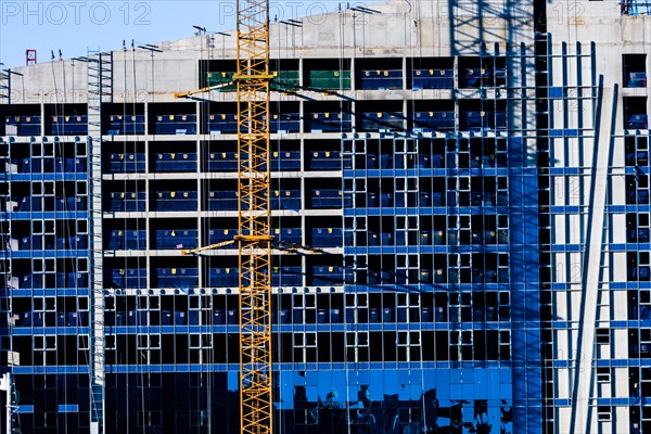 Yeoso, South Korea: December 25, 2017: Yellow crane attached to side of building that is under construction