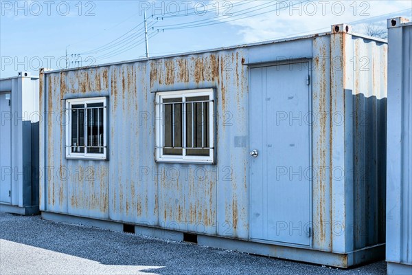 Portable corrugated metal storage buildings under cloudy sky