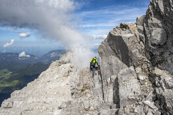 Mountaineer on a narrow rocky ridge, Watzmann crossing to Watzmann Mittelspitze, view of mountain panorama, Berchtesgaden National Park, Berchtesgaden Alps, Bavaria, Germany, Europe