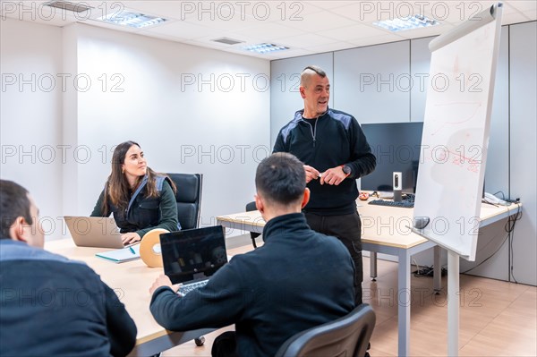 Meeting of coworkers in a meeting room of a logistics and machinery construction factory