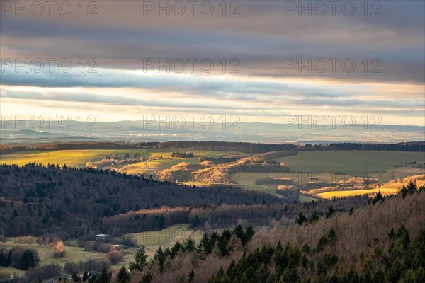 Landscape at the Grosser Zacken, Taunus volcanic region. A cloudy, sunny autumn day, meadows, hills, fields and forests with a view of the sunset. Hesse, Germany, Europe