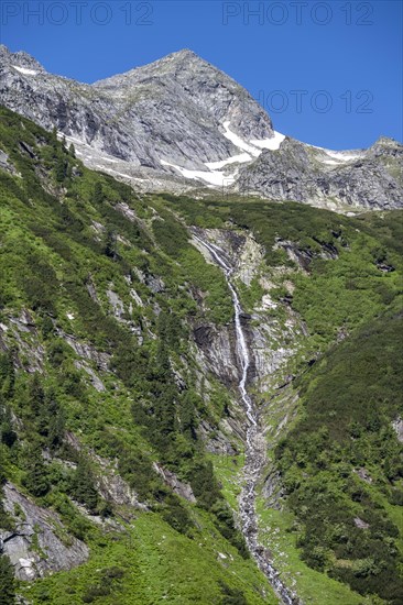 Waterfall of a mountain stream Kesselbach, rocky mountain peak, Berliner Hoehenweg, Zillertal Alps, Tyrol, Austria, Europe