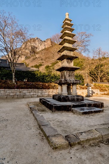Nine story stone carved Buddhist pagoda in mountain temple under blue sky
