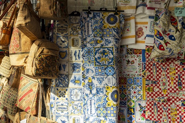 Market stand with cork bags, table cloth with traditional ornaments at city market