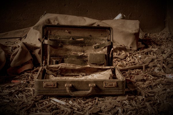 An abandoned, opened suitcase on a dirty floor in a gloomy environment, former railway junction Rethel, Lost Place, Flingern, Duesseldorf, North Rhine-Westphalia, Germany, Europe
