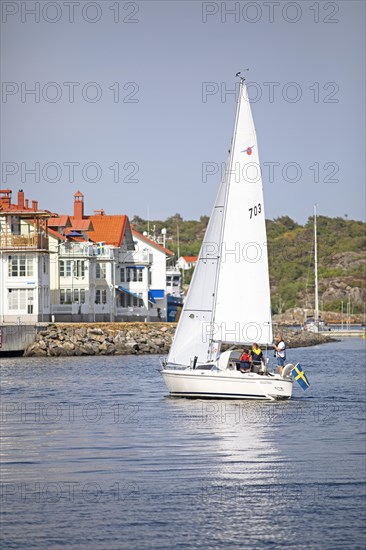 Swedish sailing boat and the archipelago island Kooen, Marstrand, Vaestra Goetalands laen, Sweden, Europe