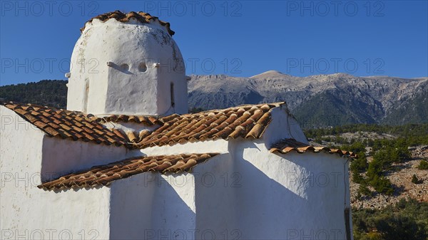 Church of St Michael the Archangel, Cross-domed church, Bright sunshine on a traditional church with a view of the mountain landscape, Aradena Gorge, Aradena, Sfakia, Crete, Greece, Europe