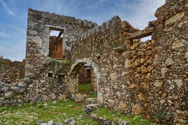 Historic ruins with window openings and a vault, surrounded by green vegetation, sky replaced, Aradena Gorge, Aradena, Sfakia, Crete, Greece, Europe