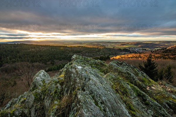 Landscape at the Grosser Zacken, Taunus volcanic region. A cloudy, sunny autumn day, meadows, hills, fields and forests with a view of the sunset. Hesse, Germany, Europe