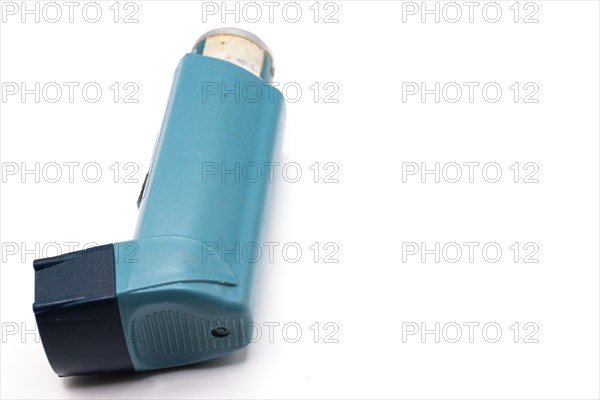 Blue asthma inhaler with blank label isolated on white background. Pharmaceutical product is used to treat or prevent asthma attack. Health and medical concept
