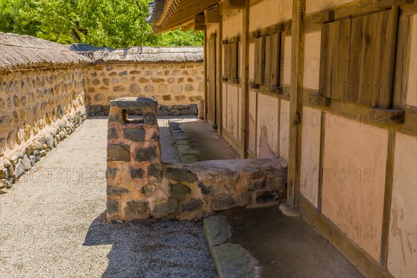 Buyeo, South Korea, July 7, 2018: Stone and mud chimney attached ancient house in traditional village located in public park at Neungsa Baekje Temple. For editorial use only, Asia