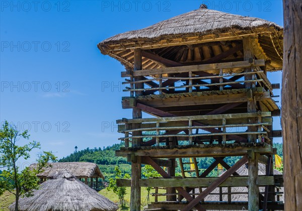 Large wooden guard tower in traditional Korean village in public park