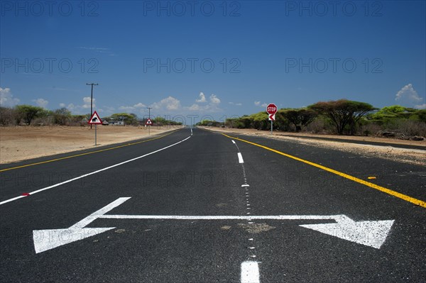 Road with double directional arrow, asphalt, confusing, direction, directional arrow, road, traffic, traffic rule, nobody, empty, lonely road trip, Botswana, Africa