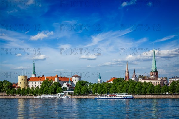 View of Riga over Daugava river: Riga Castle, St. James's Cathedral, St. Peter's Church. Riga, Latvia, Europe