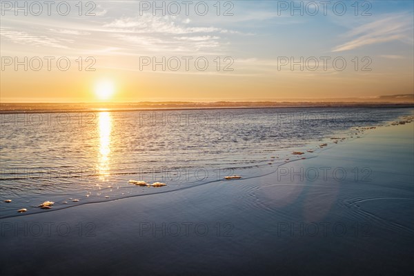 Atlantic ocean sunset with surging waves at Fonte da Telha beach, Costa da Caparica, Portugal, Europe