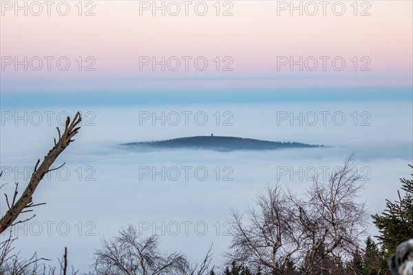 Landscape on the Grosser Feldberg, Taunus volcanic region. A cloudy, sunny winter day, meadows, hills, snow and forests with a view of the winter sunset. Hesse, Germany, Europe