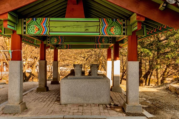 Rear view of covered water cistern with dragon head fountains at Buddhist temple