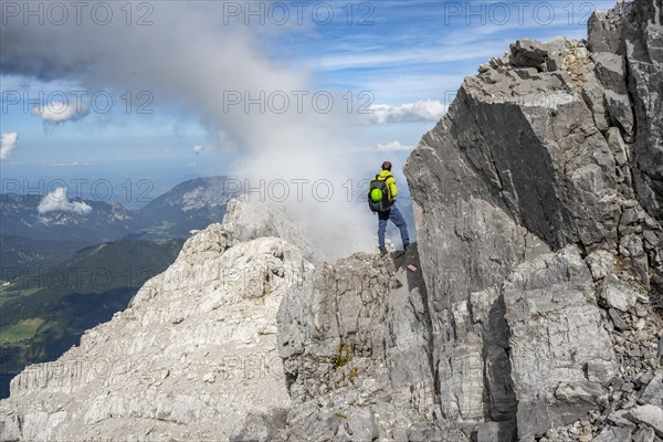 Mountaineer on a narrow rocky ridge, Watzmann crossing to Watzmann Mittelspitze, view of mountain panorama, Berchtesgaden National Park, Berchtesgaden Alps, Bavaria, Germany, Europe