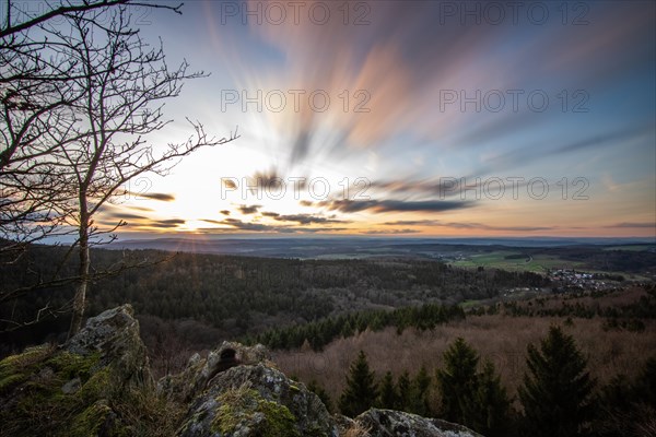 Landscape at the Grosser Zacken, Taunus volcanic region. A cloudy, sunny autumn day, meadows, hills, fields and forests with a view of the sunset. Hesse, Germany, Europe