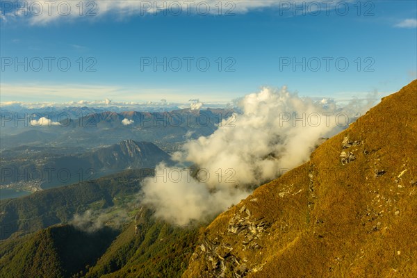 Aerial View over Beautiful Mountainscape with Clouds and Lake Lugano and City of Lugano in a Sunny Day in Ticino, Switzerland, Europe